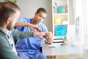 Doctor examining a patient's wrist