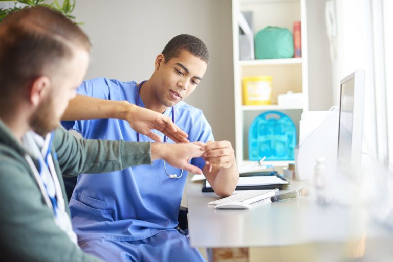 Doctor examining a patient's wrist
