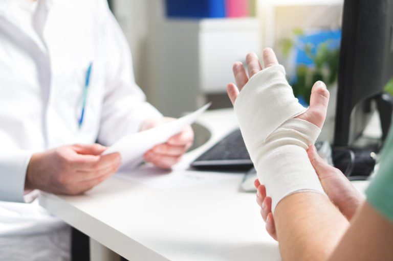 Patient with their wrist sprain wrapped