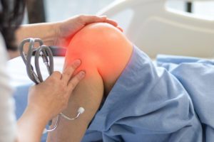 A patient with knee bursitis being checked out by an orthopedic doctor.