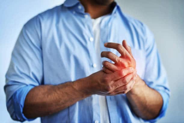 Closeup shot of an unidentifiable businessman suffering with pain in his hands