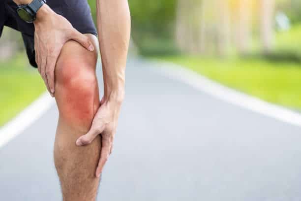 Young adult male with muscle pain during running. runner have knee ache due to Runners Knee or Patellofemoral Pain Syndrome, osteoarthritis and Patellar Tendinitis. Sports injuries and medical concept