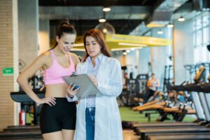 Sports medicine physician shows instructions to a woman athlete