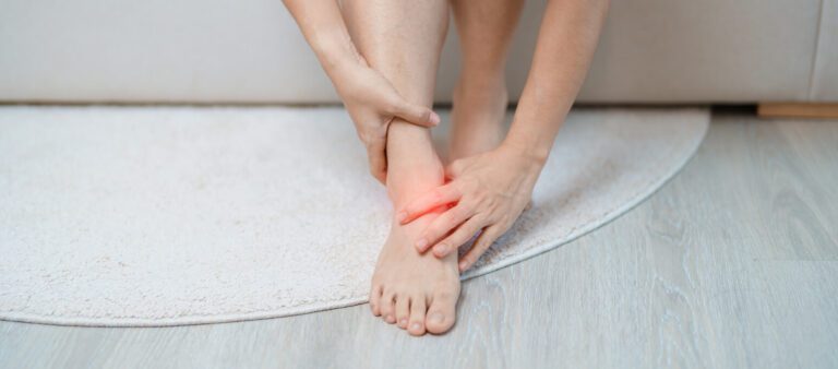 A woman suffering from leg pain due to ankle sprains, Achilles tendonitis, or shin splints.