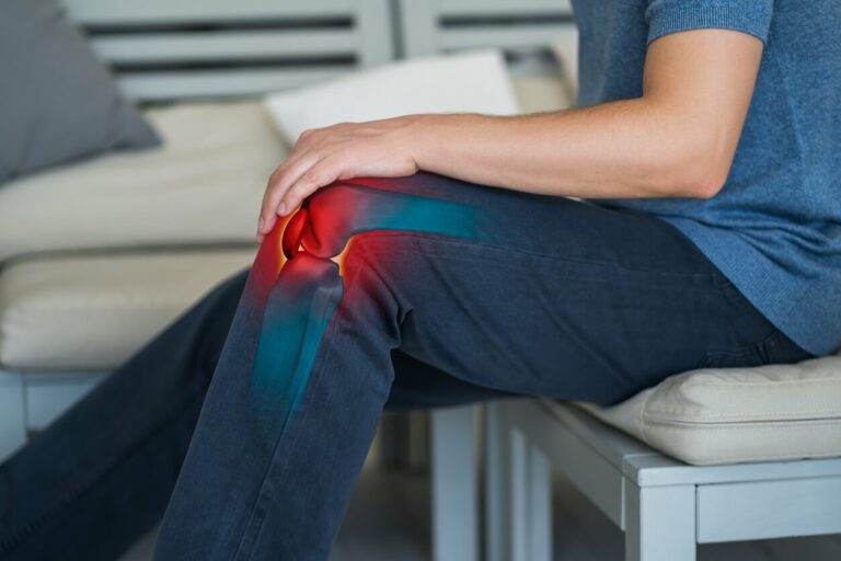 Knee pain, man suffering from knee bursitis at home.