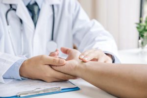 Doctor examining a sprained wrist