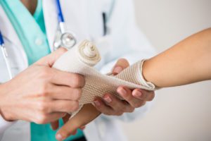 Doctor wrapping a patient's wrist