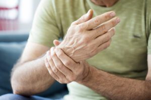 A Middle Age person suffering with Hand Pain