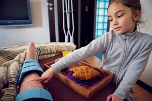 Little girl is touching Knee surgery scar of her father