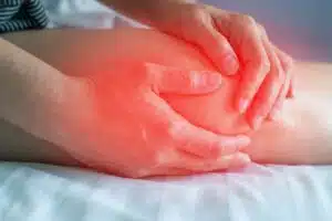 Knee pain disease concept. Hands on leg as hurt from bursitis