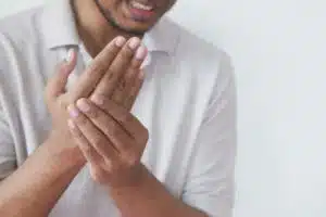 man suffering pain in hand close up .