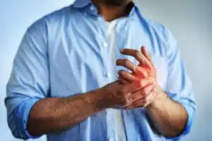 Closeup shot of an unidentifiable businessman suffering with pain in his hands