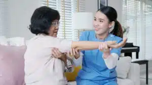 A female therapist working with senior patient during osteoporosis care in clinic.